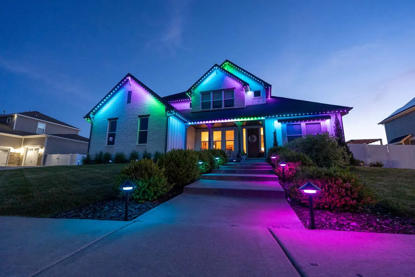 Home and landscaping lit in purple with Happy's landscape lights